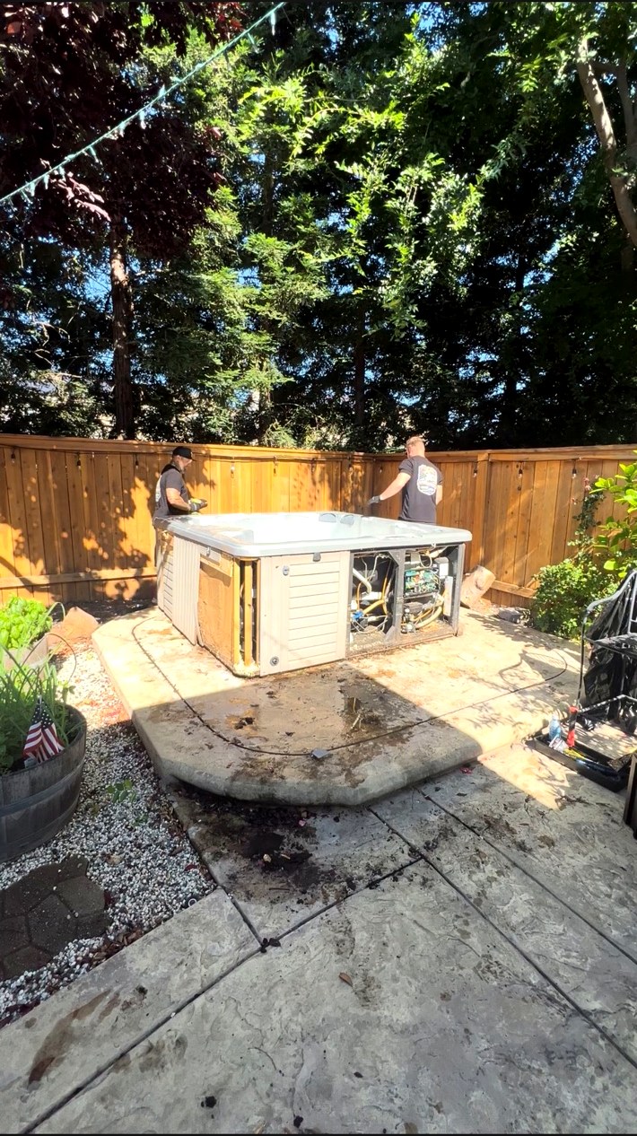 AMR Junk Removal crew removing an old hot tub from a backyard in Placer County